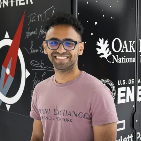 Ritvik Prabhu beside the Frontier supercomputer at Oak Ridge National Laboratory